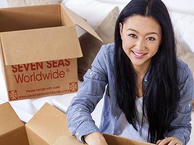 Young lady packing boxes