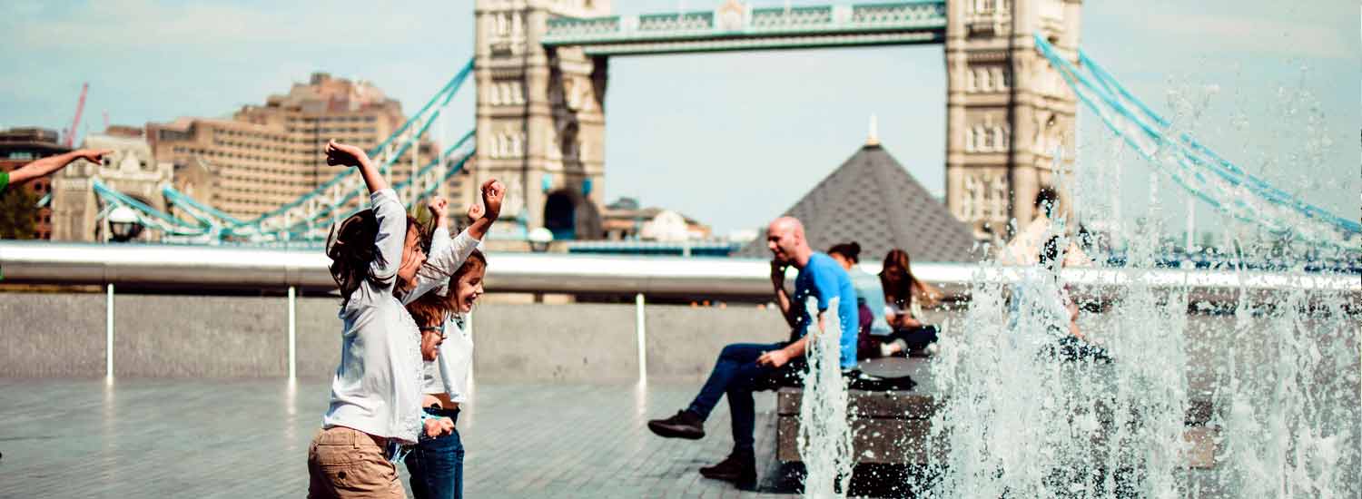 Children playing in fountains by Tower Bridge in London