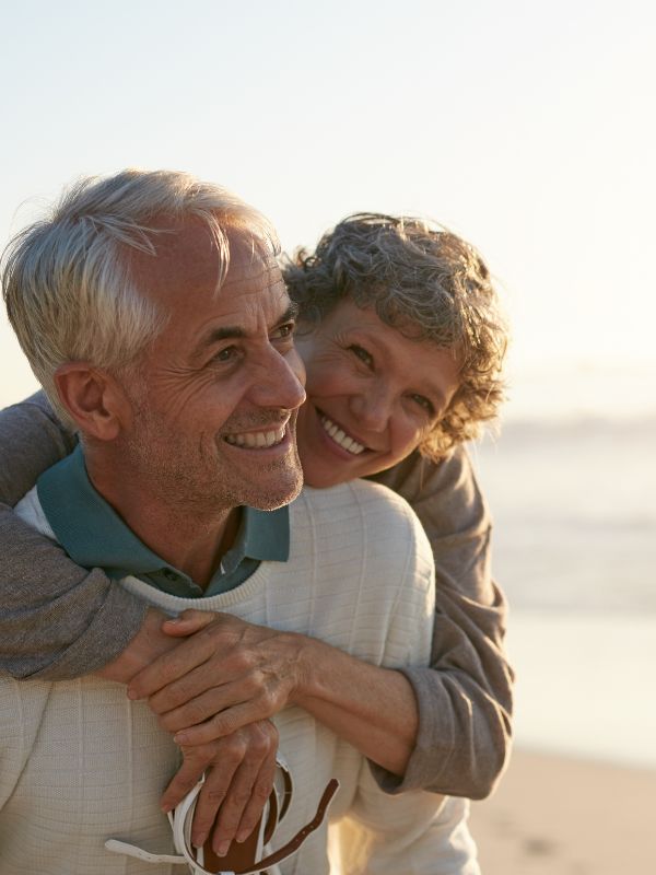 Smiling older couple on a beach