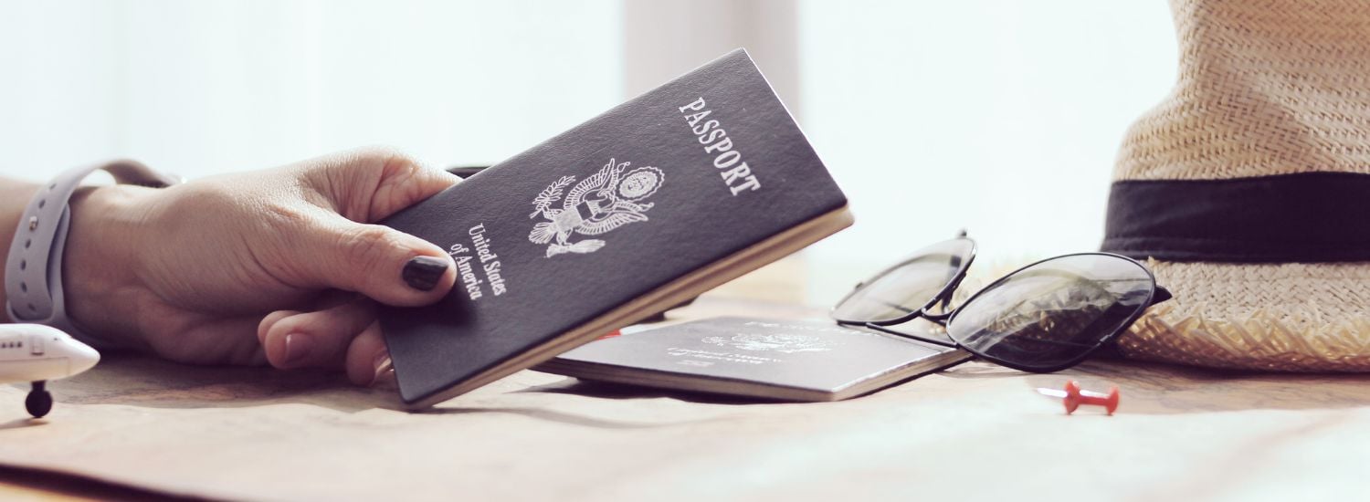 Womans hand holding an American passports