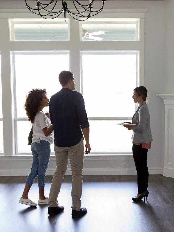 Couple being shown a property to buy or rent in the UK