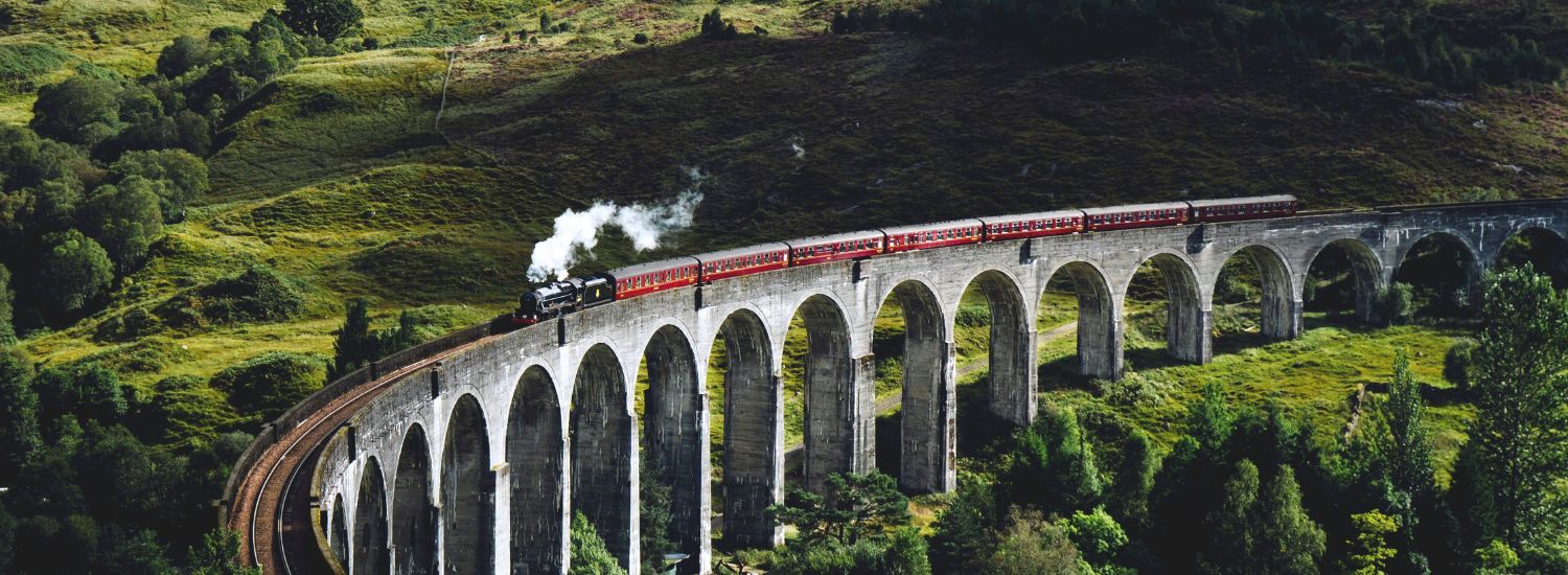 Steam train crossing a viaduct in Scotland