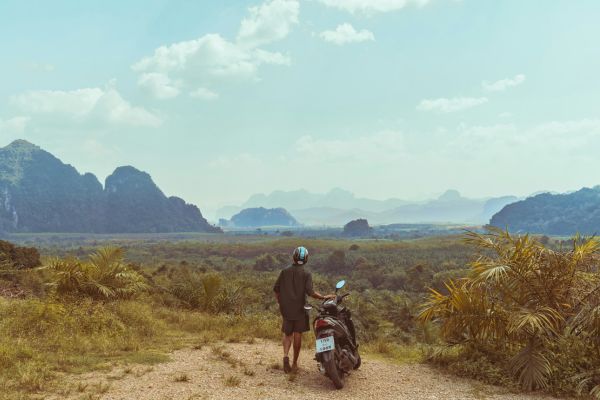 Motorbike rider looking out over the mountains