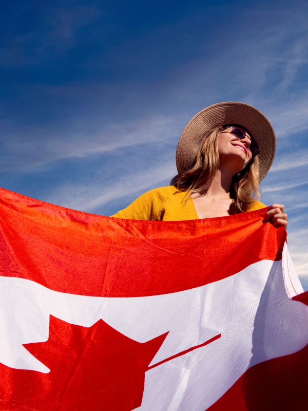 Smiling woman holding a Canadian flag