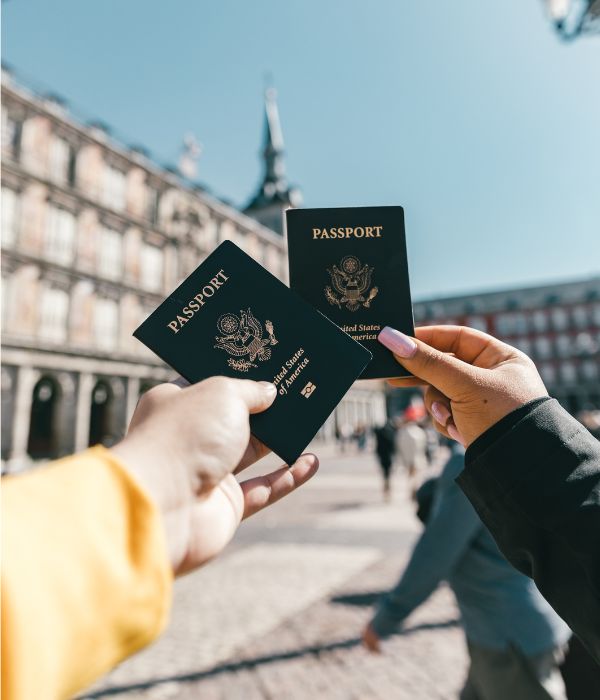 Two people holding passports