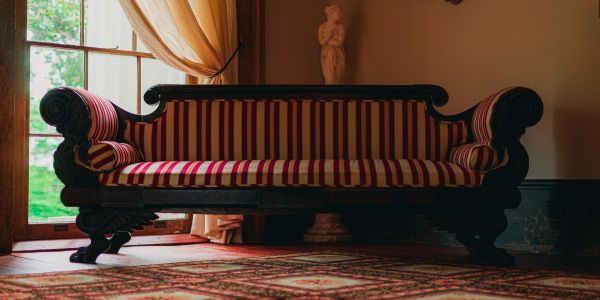 Antique couch next to a window