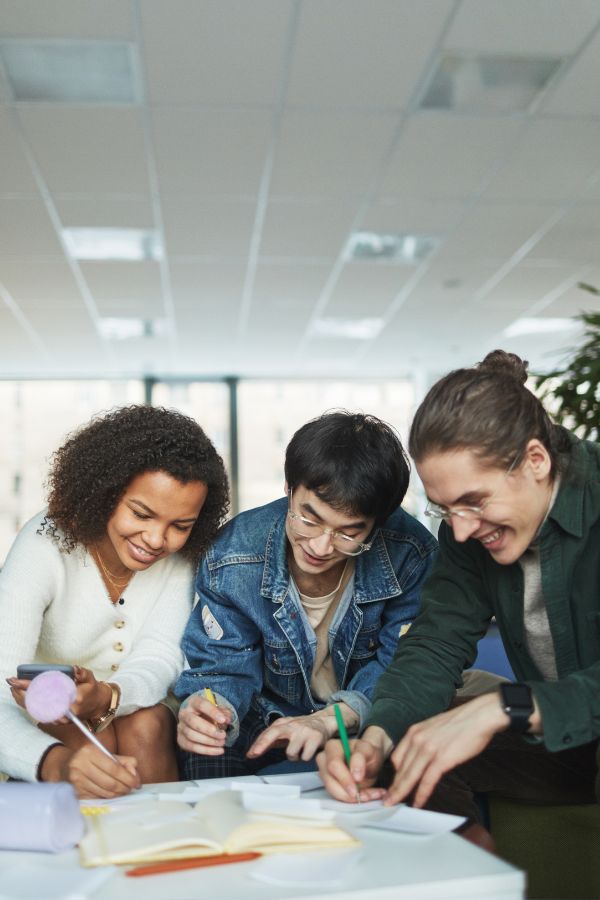 Three high-school students working together