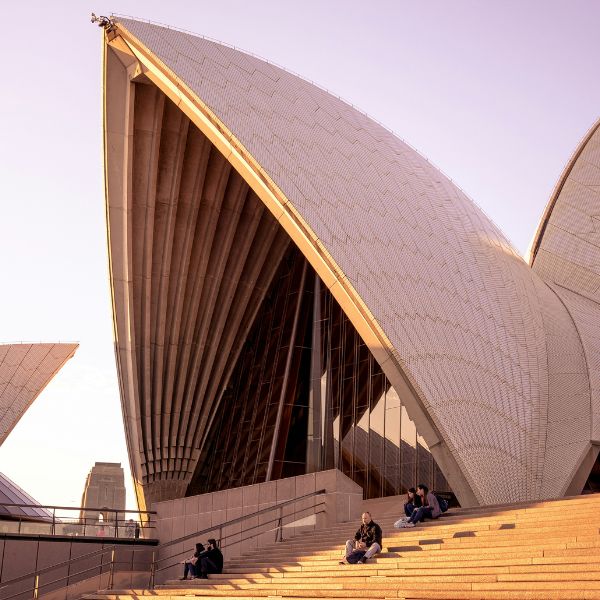People sitting on the steps outside Sydney Opera House in Australia