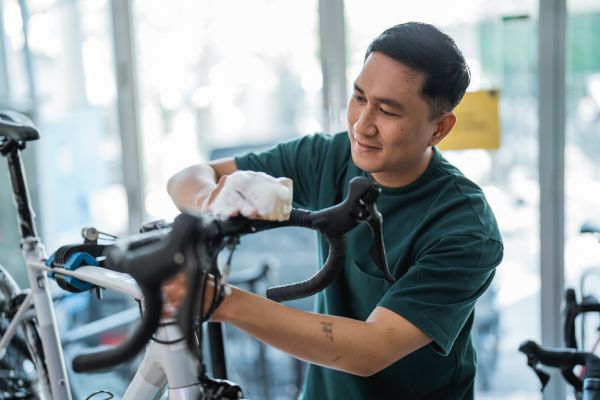 Man a cleaning a bike