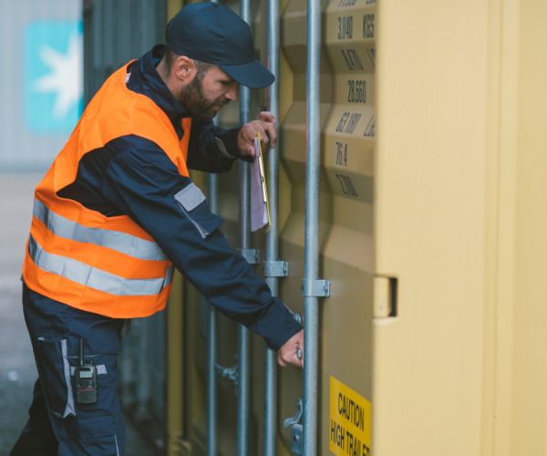 Customs official checking shipping containers