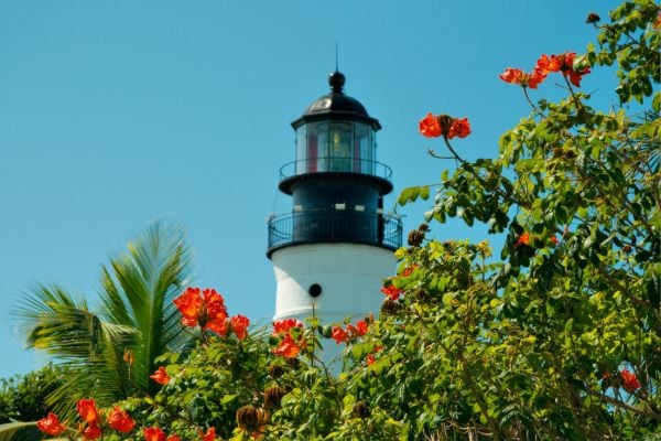 Lighthouse framed by colourful flowers in Key West, Florida