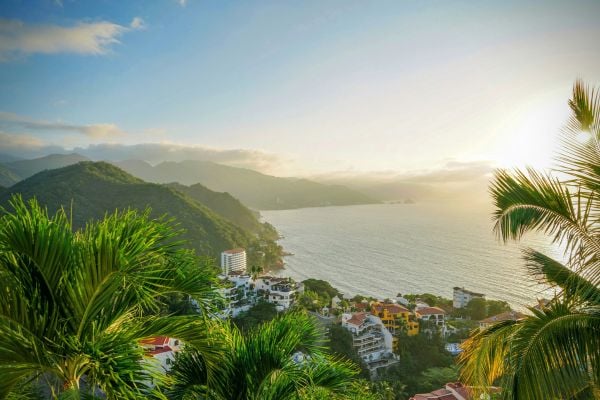 City surrounded by lush jungle and mountains beside the ocean in Puerto Rico