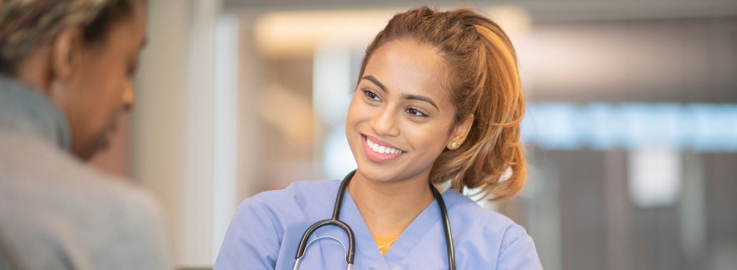 Smiling nurse helping a patient