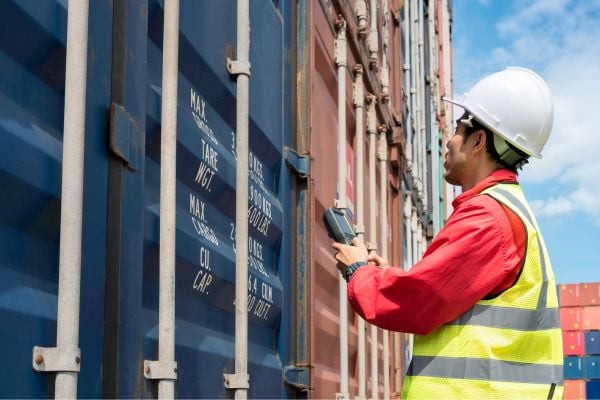 Dock worker processing shipping containers