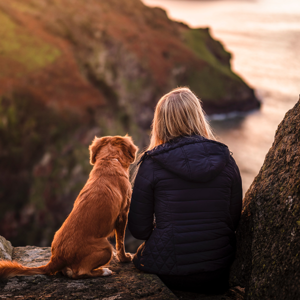 Woman with a dog sitting outdoors