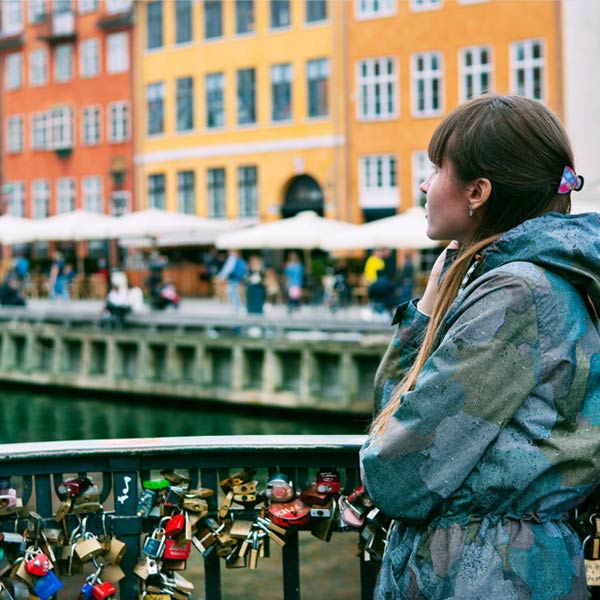 Woman on a bridge in Denmark looking at the river