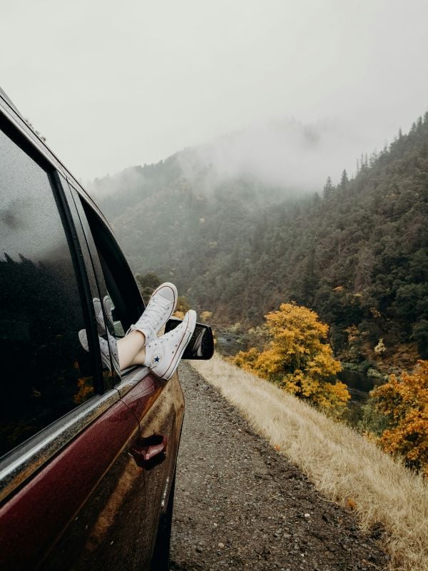 Feet hanging outside a car window