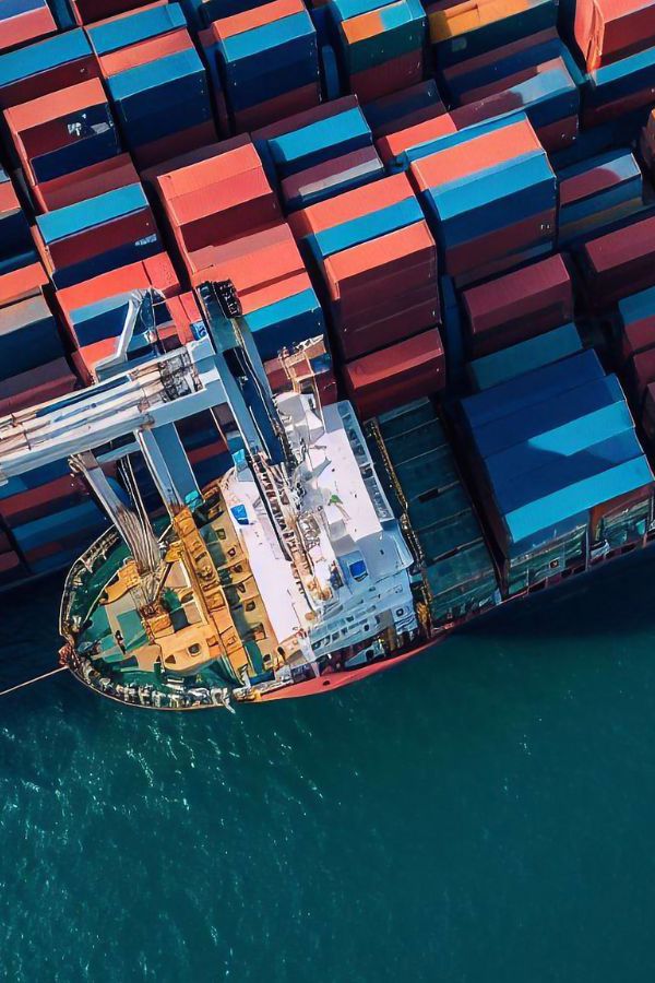 Birds eye view of shipping containers being loaded onto a cargo ship