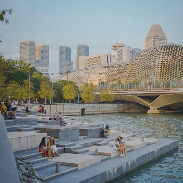 Singapore Harbour with people sitting on steps by the water