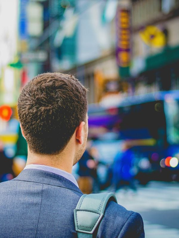 Man in a suit walking in city